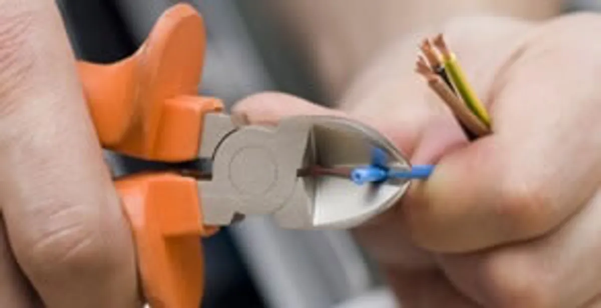 professional electrical services showing precise wire cutting by licensed electricians in Scottsdale, AZ