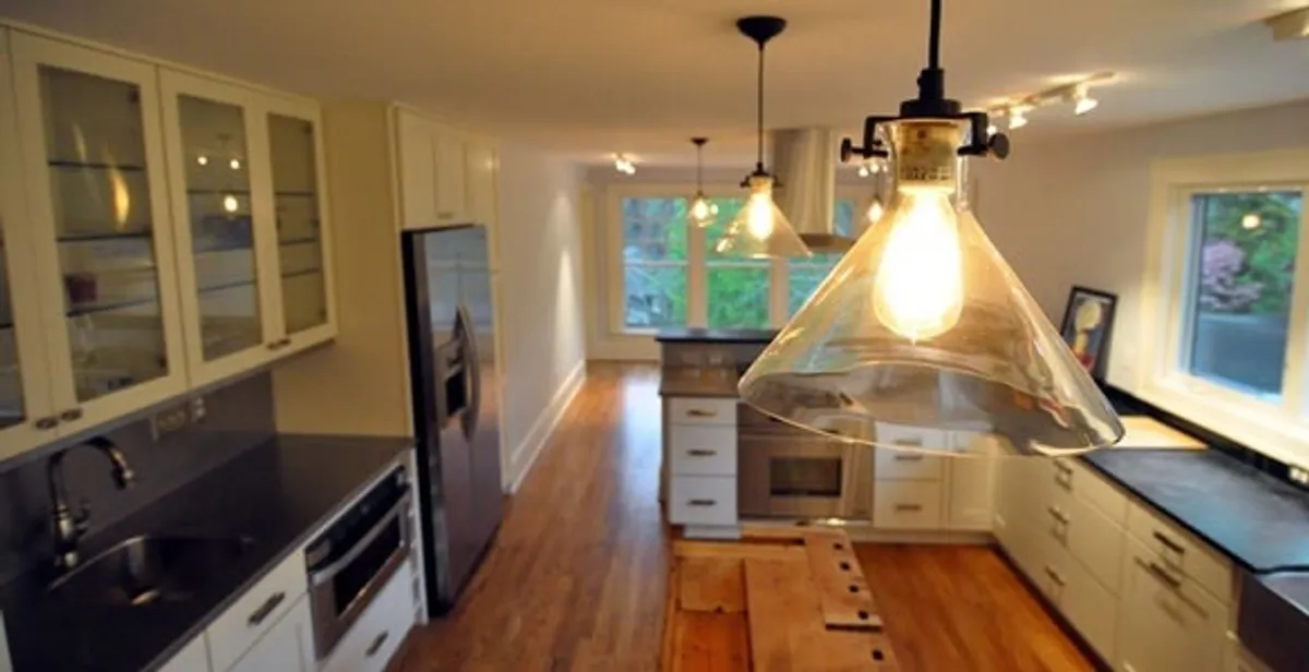 Residential electrician installing modern indoor light fixture in a home in Scottsdale, AZ